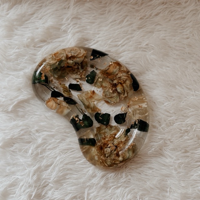 Bean-shaped resin trinket tray with preserved cream roses, eucalyptus leaves, and gold flakes